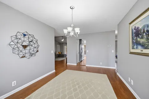 a bedroom with bed and a chandelier