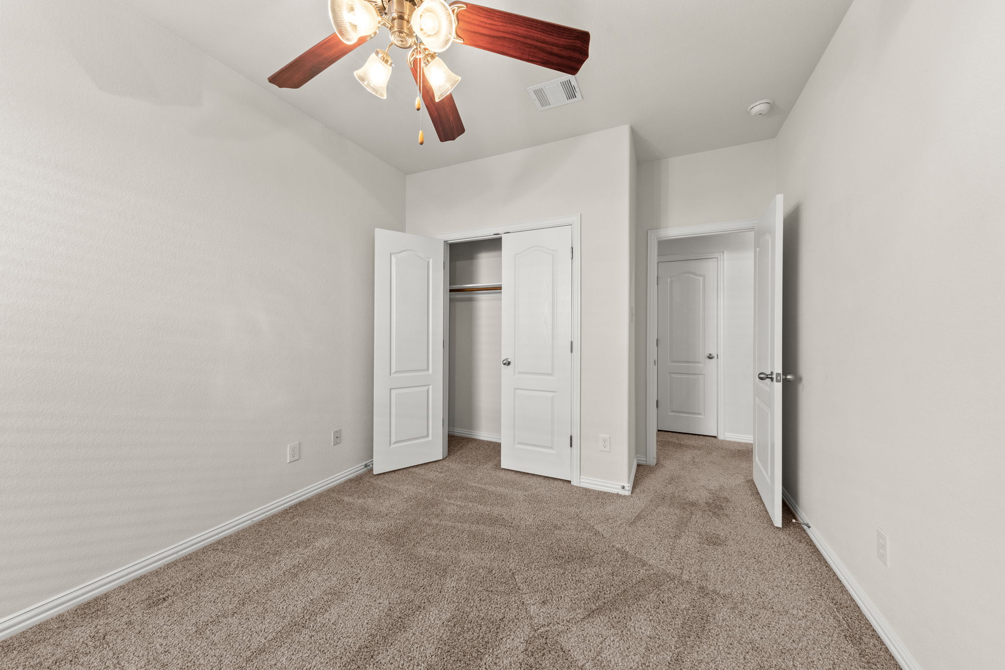 411 Tascate Street Georgetown, TX 78628 - Photo 33 of 41 A comfortable bedroom features plush carpeting and a convenient reach-in closet.