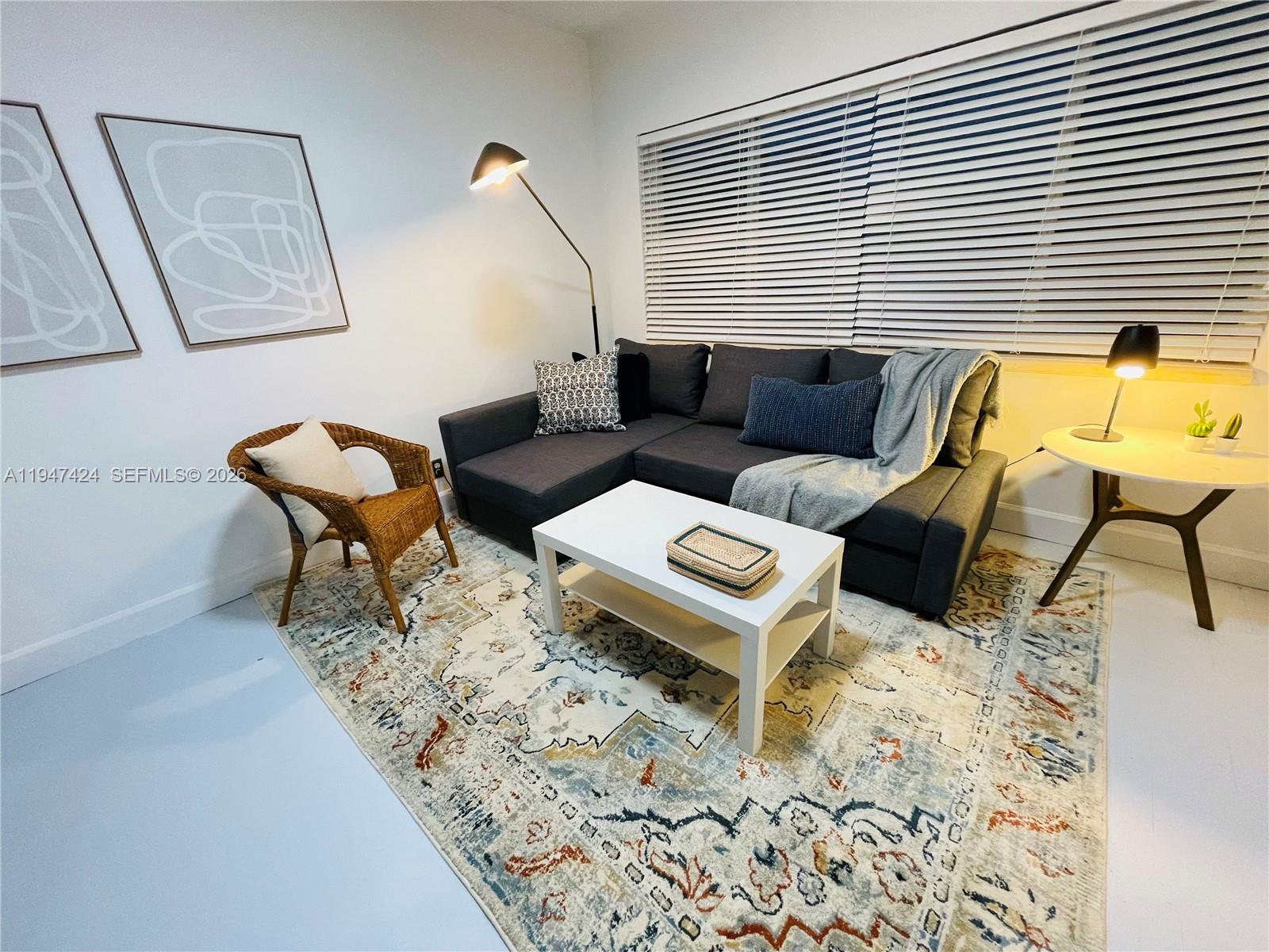 8036 Harding Avenue, Unit 1 Miami Beach, FL 33141 - Photo 11 of 33 a living room with furniture and a window
