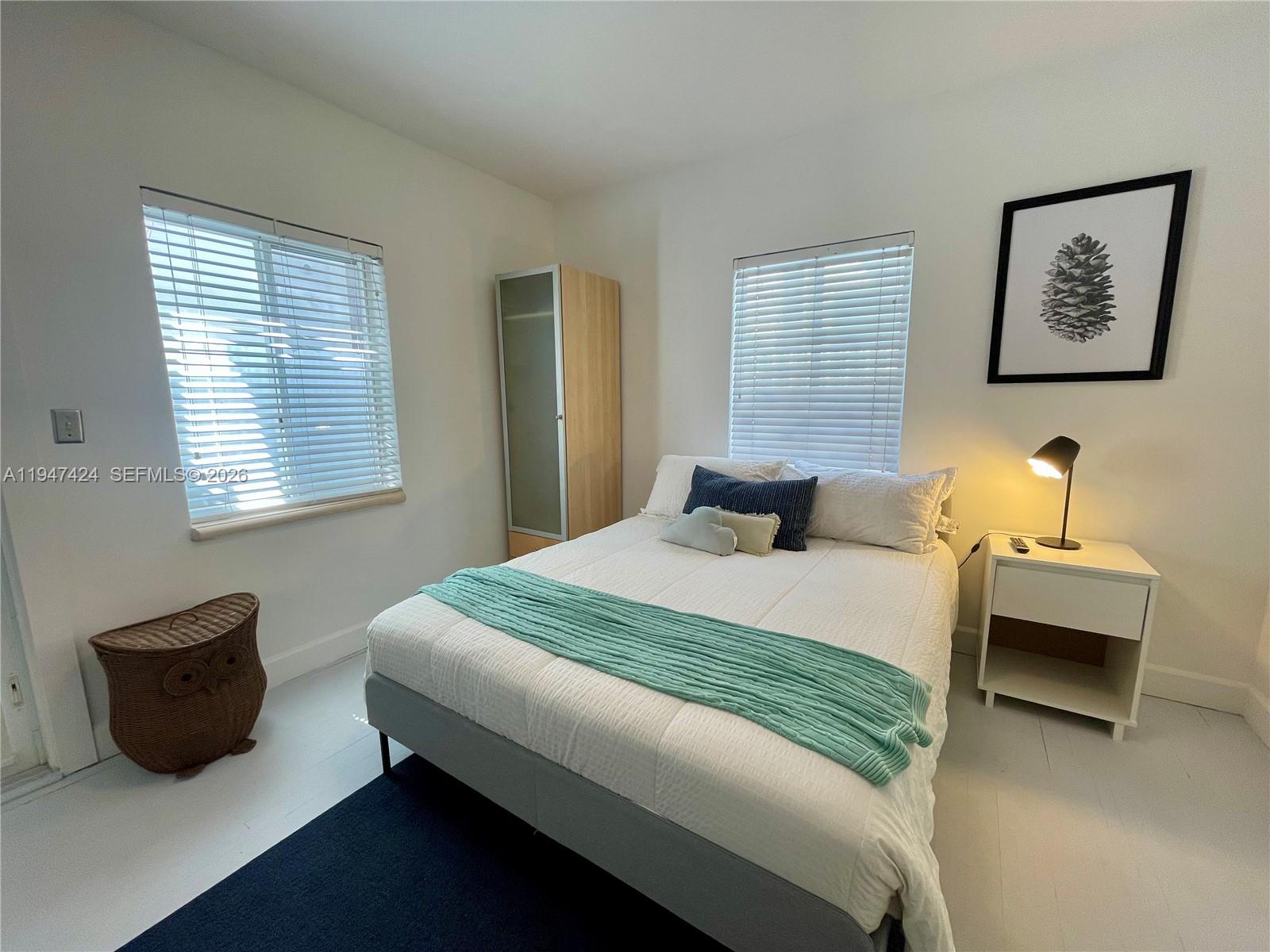 8036 Harding Avenue, Unit 1 Miami Beach, FL 33141 - Photo 14 of 33 a bedroom with bed and a window