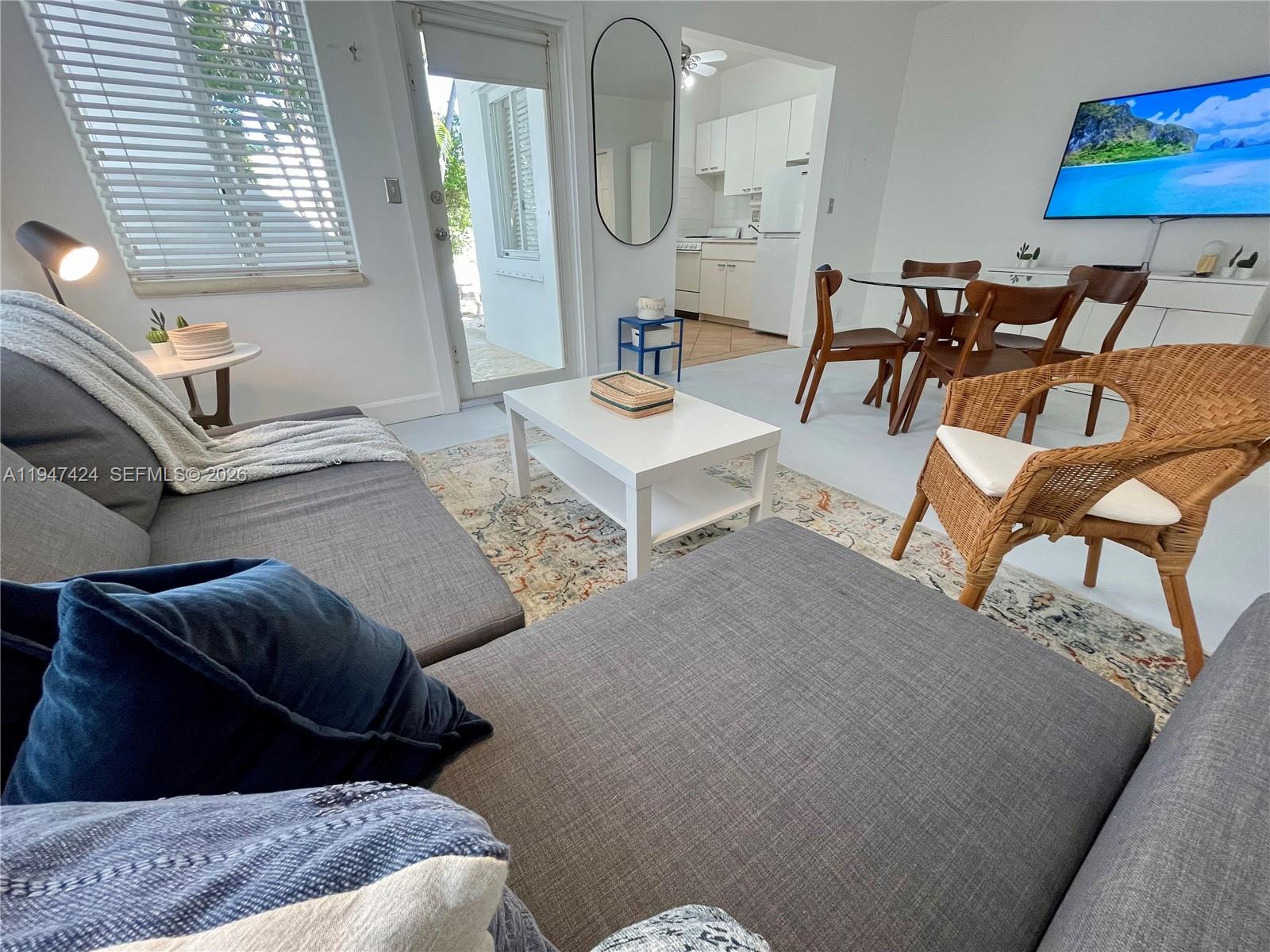 8036 Harding Avenue, Unit 1 Miami Beach, FL 33141 - Photo 16 of 33 a living room with furniture and a mirror