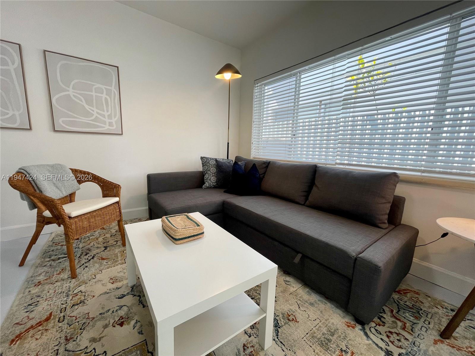 8036 Harding Avenue, Unit 1 Miami Beach, FL 33141 - Photo 18 of 33 a living room with furniture and a window