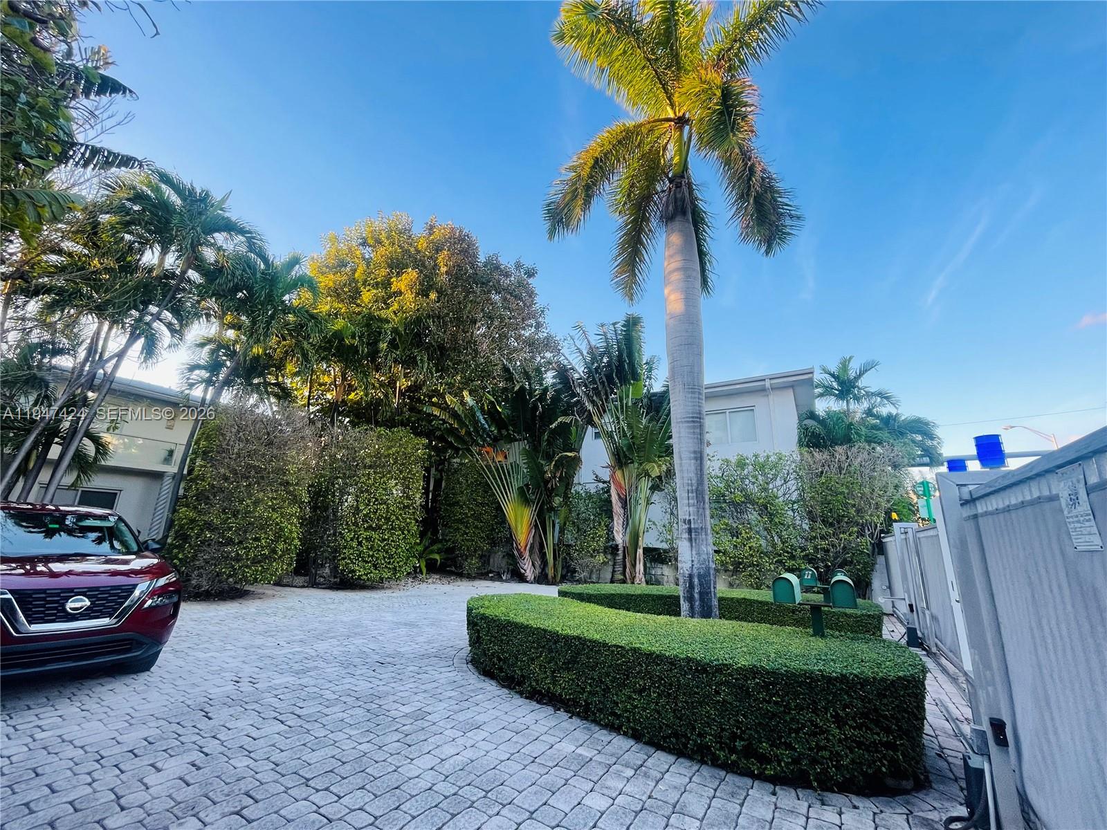 8036 Harding Avenue, Unit 1 Miami Beach, FL 33141 - Photo 2 of 33 a view of a backyard with a garden