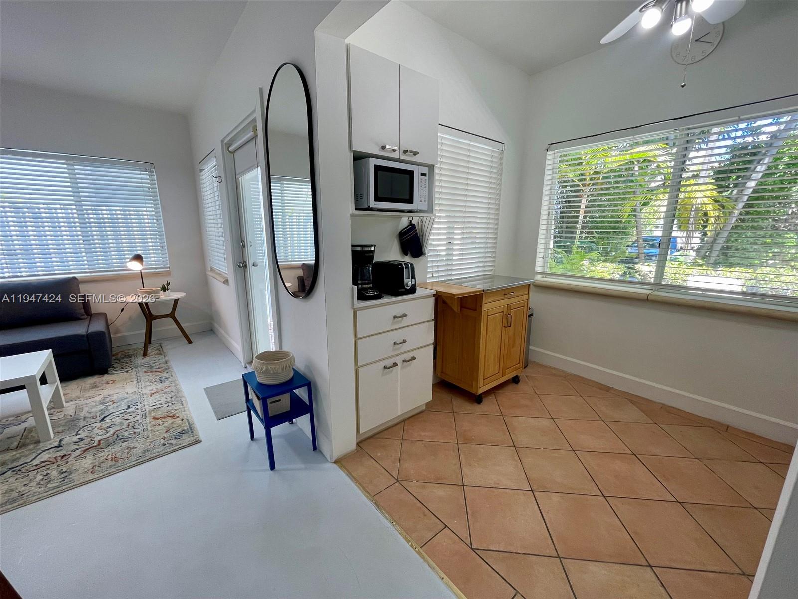 8036 Harding Avenue, Unit 1 Miami Beach, FL 33141 - Photo 22 of 33 a kitchen with stainless steel appliances granite countertop a refrigerator and a stove top oven