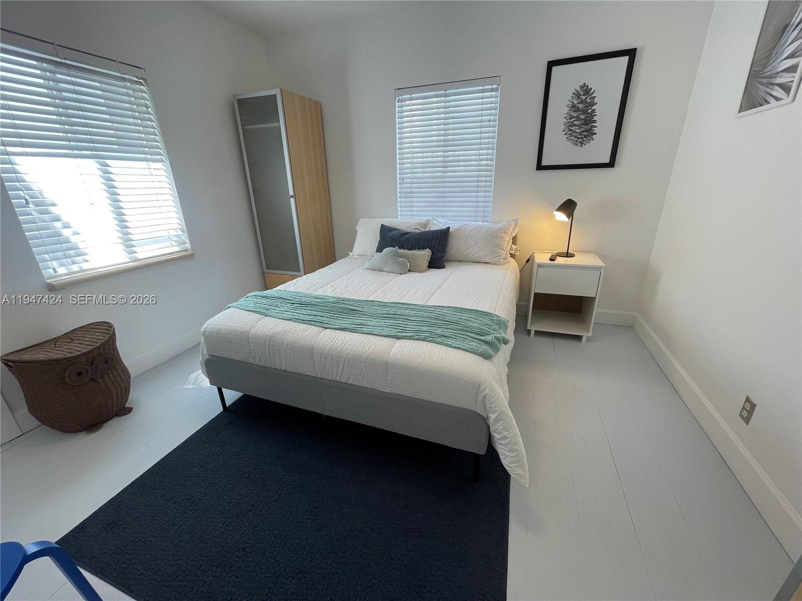8036 Harding Avenue, Unit 1 Miami Beach, FL 33141 - Photo 29 of 33 a bedroom with a bed and a window