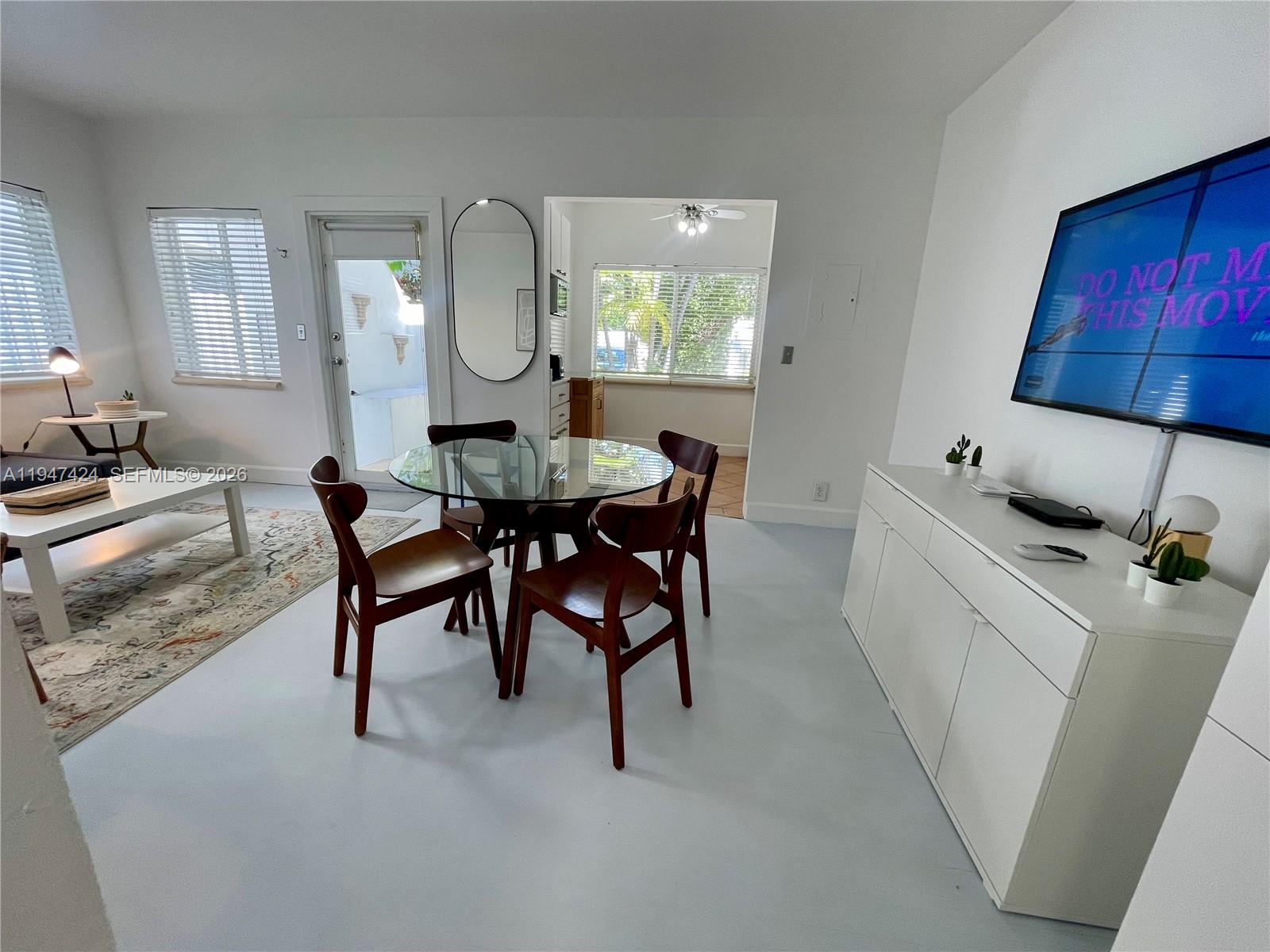 8036 Harding Avenue, Unit 1 Miami Beach, FL 33141 - Photo 30 of 33 a kitchen with a table chairs and a dining table
