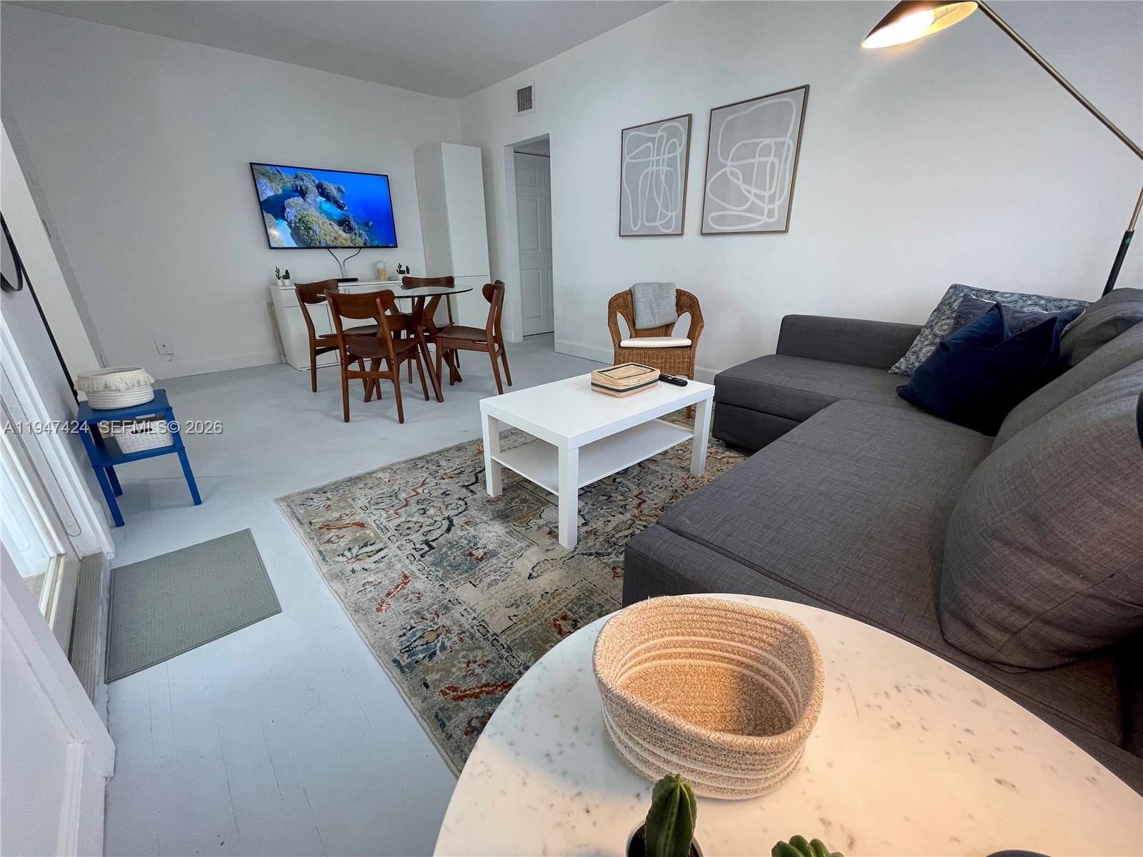 8036 Harding Avenue, Unit 1 Miami Beach, FL 33141 - Photo 32 of 33 a living room with furniture and a rug
