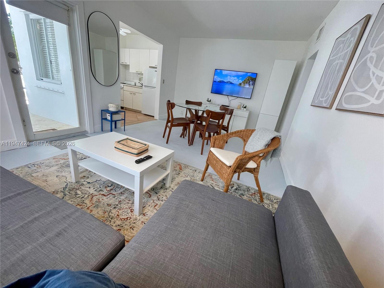 8036 Harding Avenue, Unit 1 Miami Beach, FL 33141 - Photo 33 of 33 a living room with furniture and a mirror