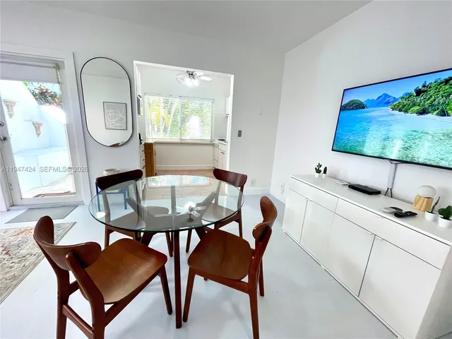 a view of a dining room with furniture and a window