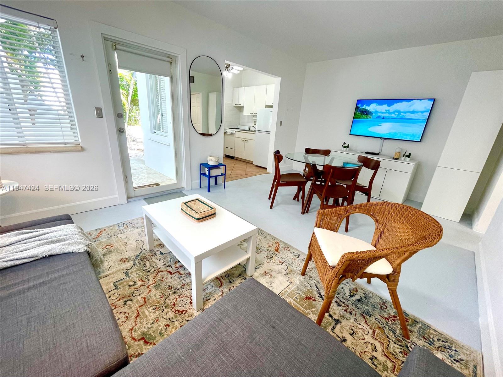 8036 Harding Avenue, Unit 1 Miami Beach, FL 33141 - Photo 7 of 33 a living room with furniture and a large window