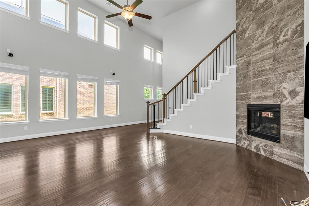 6333 Hall Road Frisco, TX 75034 - Photo 9 of 38 Expansive living area featuring soaring ceilings and wood-finish flooring