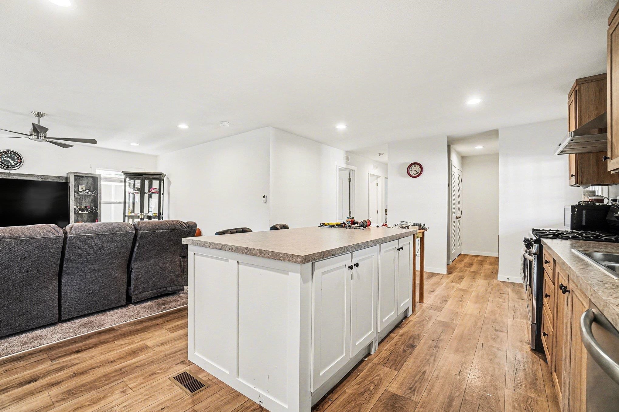 16711 Marsh Creek Road, Unit 150 Clayton, CA 94517 - Photo 11 of 19 a large kitchen with stainless steel appliances granite countertop a lot of counter space and wooden floor