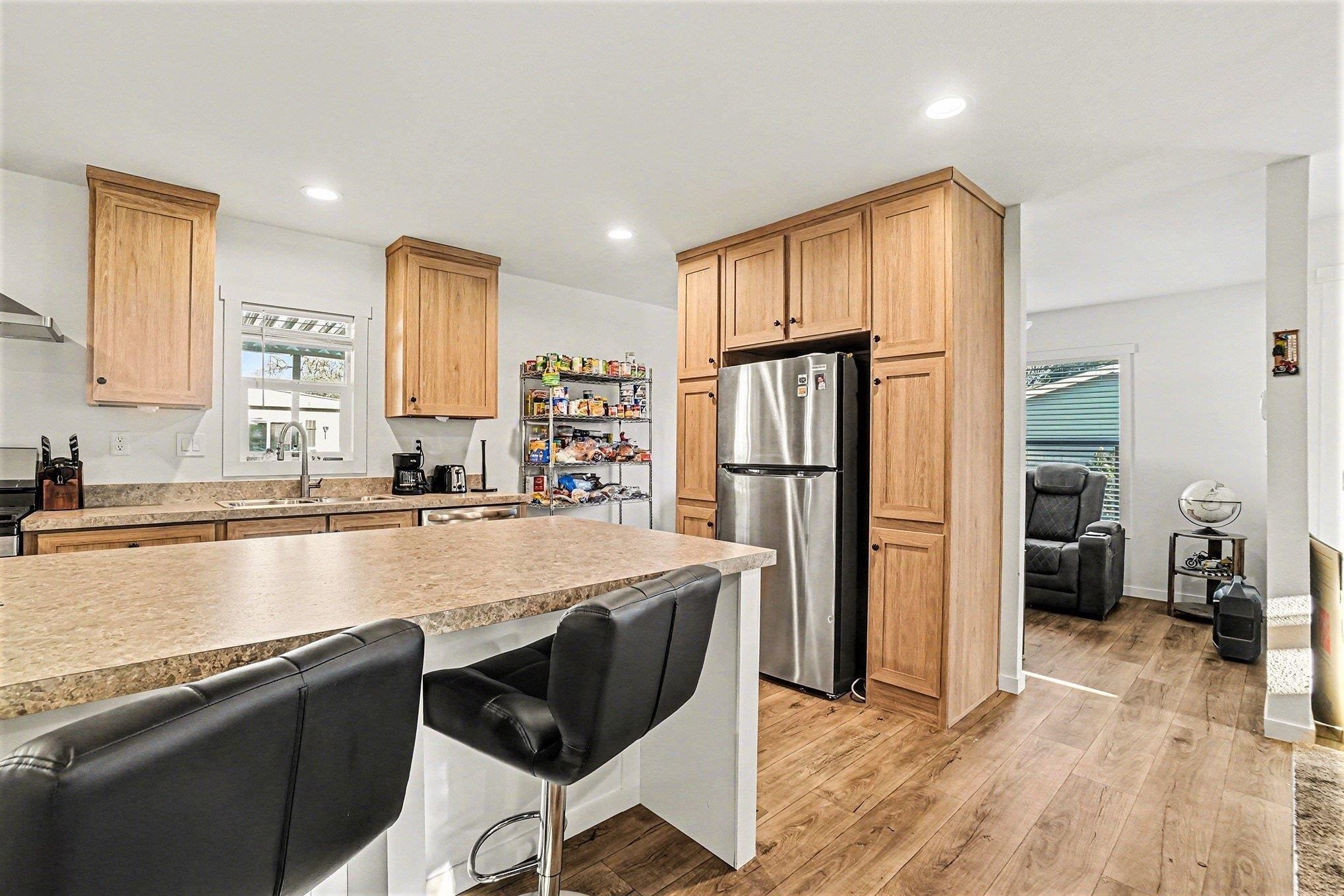 16711 Marsh Creek Road, Unit 150 Clayton, CA 94517 - Photo 10 of 19 a large kitchen with kitchen island a large counter top space and stainless steel appliances