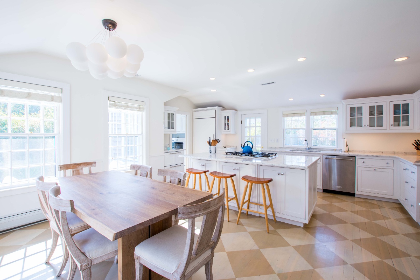 60 Cliff Road Nantucket, MA 02554 - Photo 14 of 54 a dining hall with stainless steel appliances a table and chairs in it