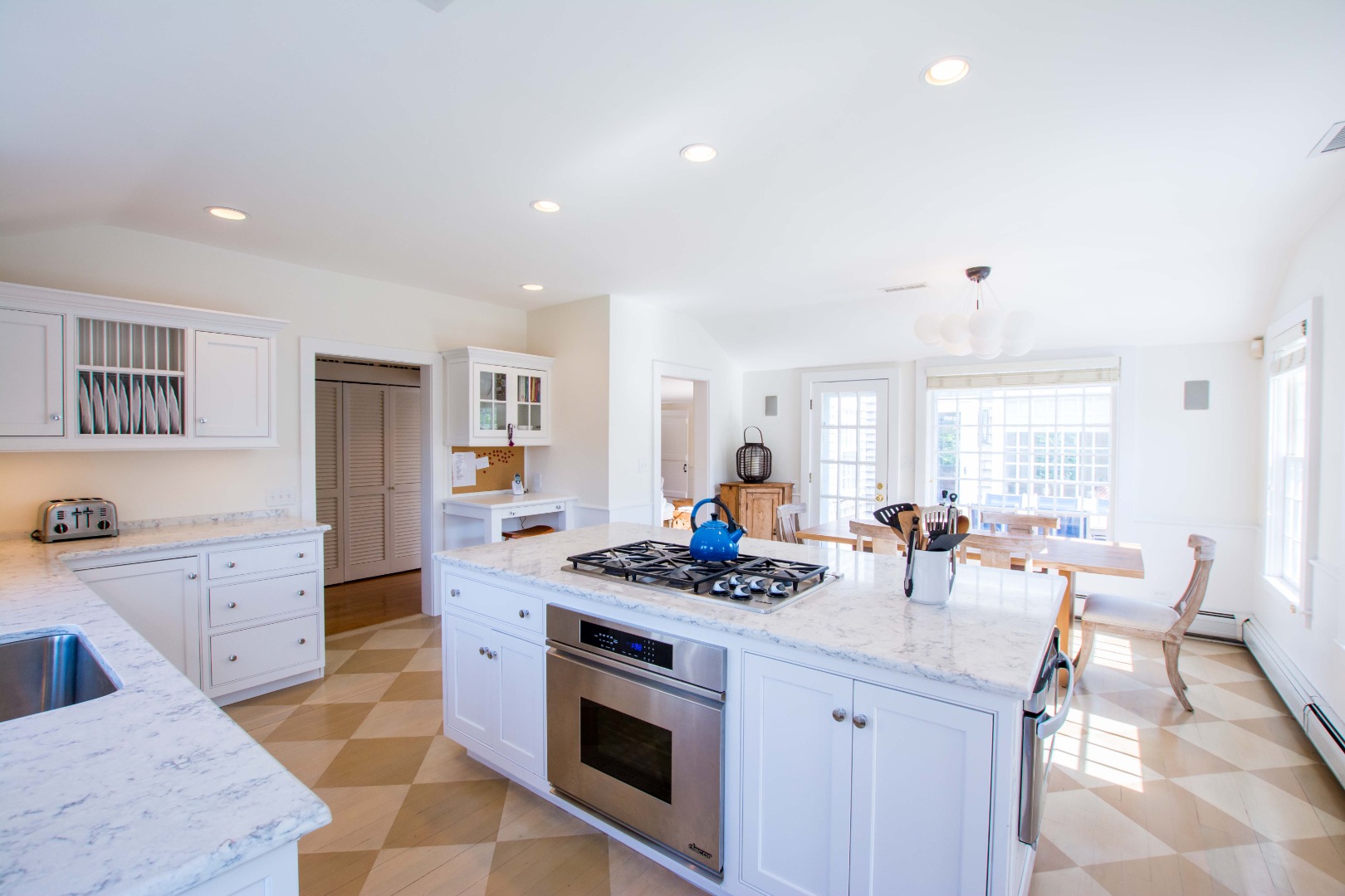 60 Cliff Road Nantucket, MA 02554 - Photo 17 of 54 a kitchen with stainless steel appliances kitchen island granite countertop a stove and a sink