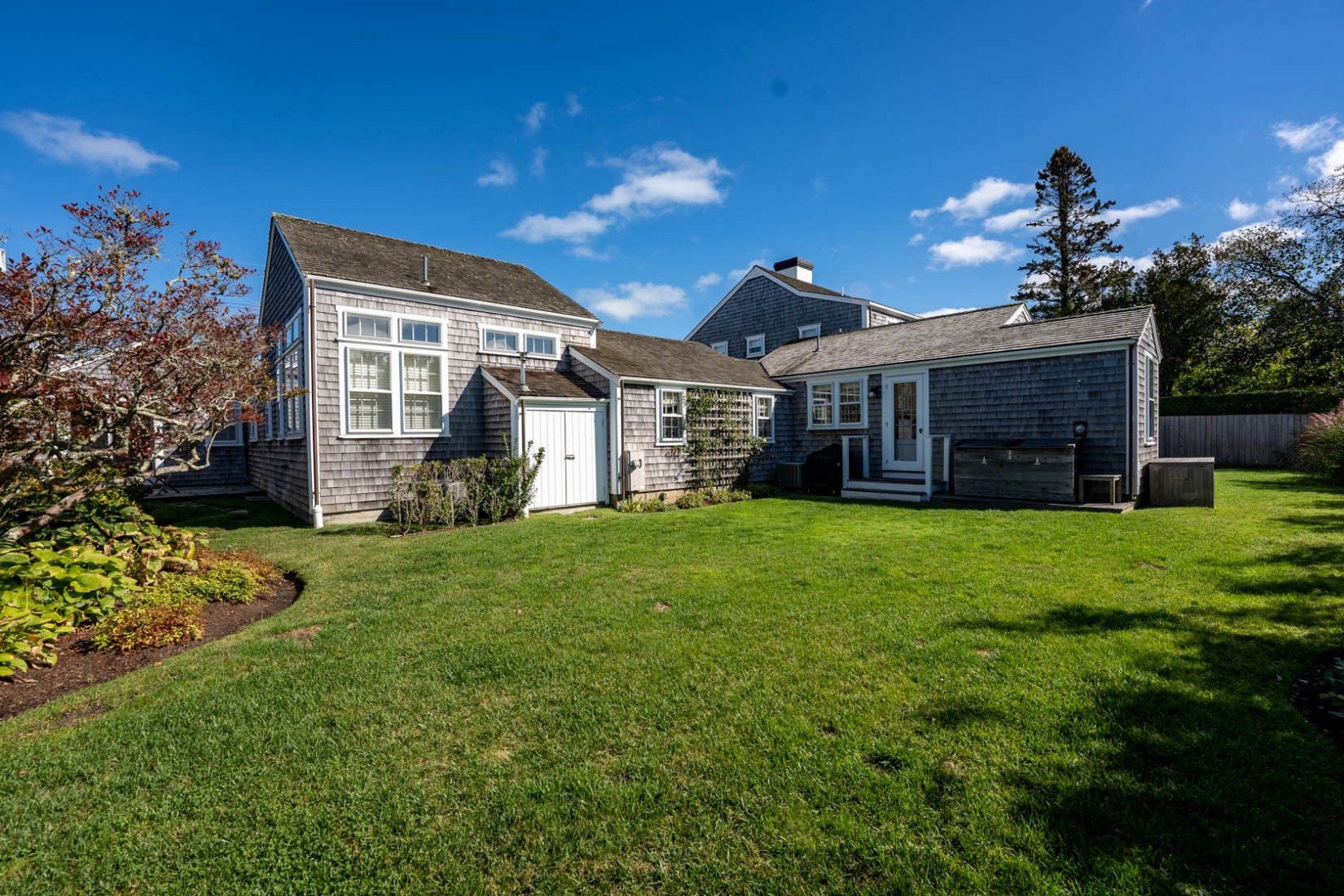 60 Cliff Road Nantucket, MA 02554 - Photo 7 of 54 a view of a house with a big yard and potted plants