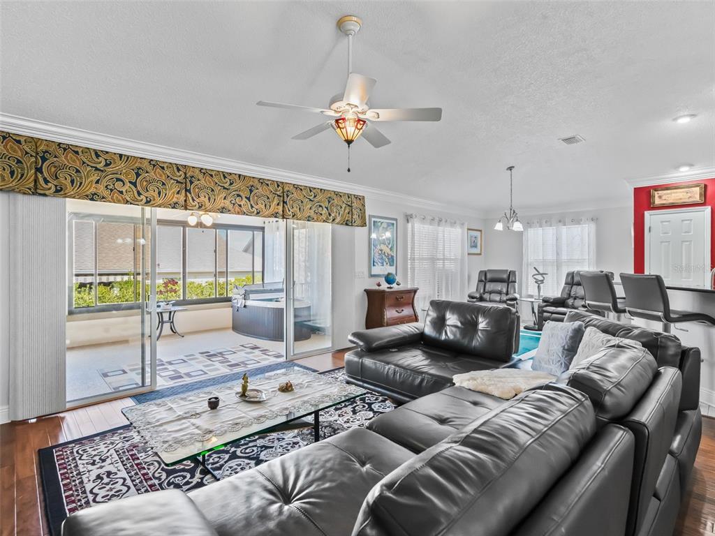 1085 Ridgeland Path The Villages, FL 32162 - Photo 13 of 56 a living room with furniture kitchen view and a chandelier