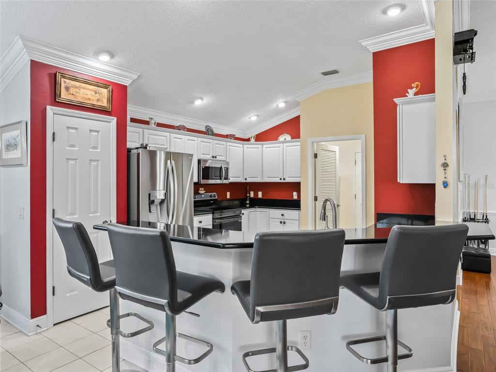 1085 Ridgeland Path The Villages, FL 32162 - Photo 18 of 56 a dining room with furniture and a kitchen