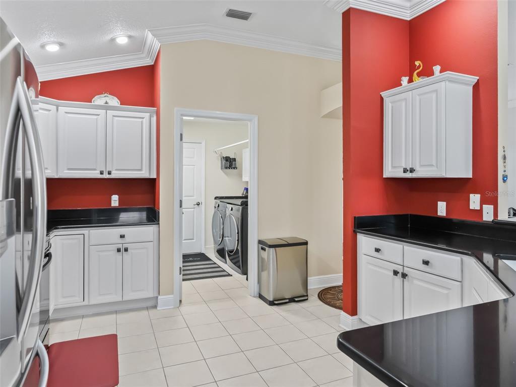 1085 Ridgeland Path The Villages, FL 32162 - Photo 20 of 56 a kitchen with stainless steel appliances cabinets and a stove top oven