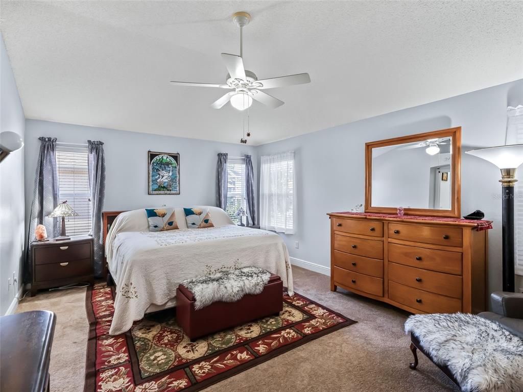1085 Ridgeland Path The Villages, FL 32162 - Photo 27 of 56 a bedroom with a bed and a dresser