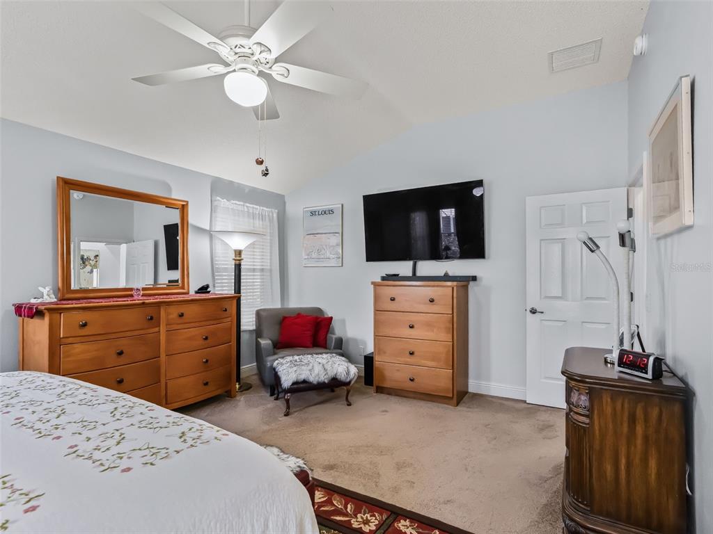 1085 Ridgeland Path The Villages, FL 32162 - Photo 29 of 56 a bed room with a bed and a flat screen tv