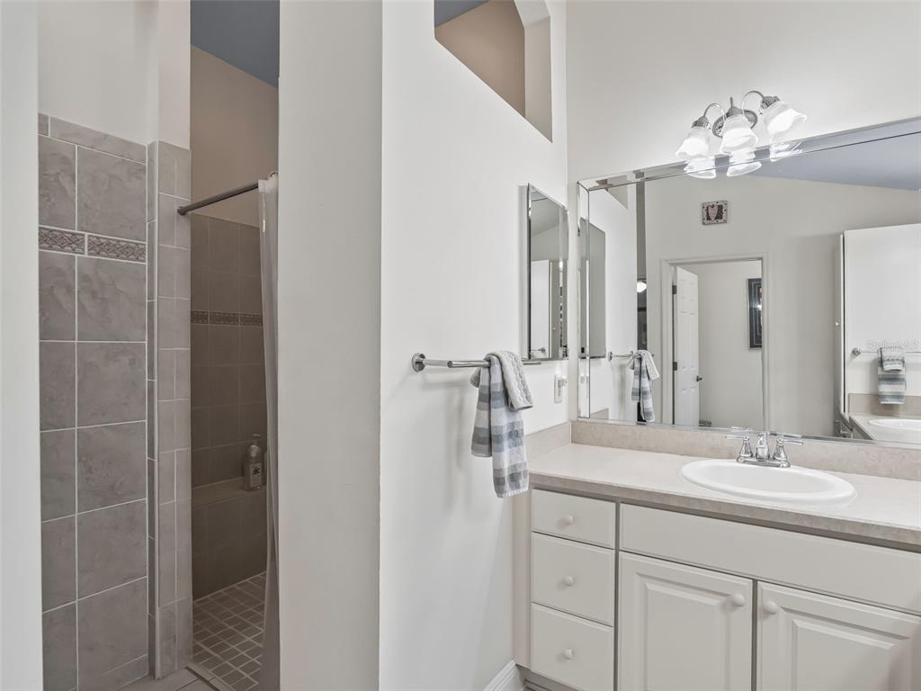 1085 Ridgeland Path The Villages, FL 32162 - Photo 32 of 56 a bathroom with a double vanity sink and mirror