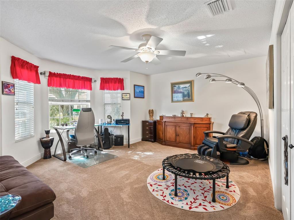 1085 Ridgeland Path The Villages, FL 32162 - Photo 33 of 56 a living room with furniture and a chandelier