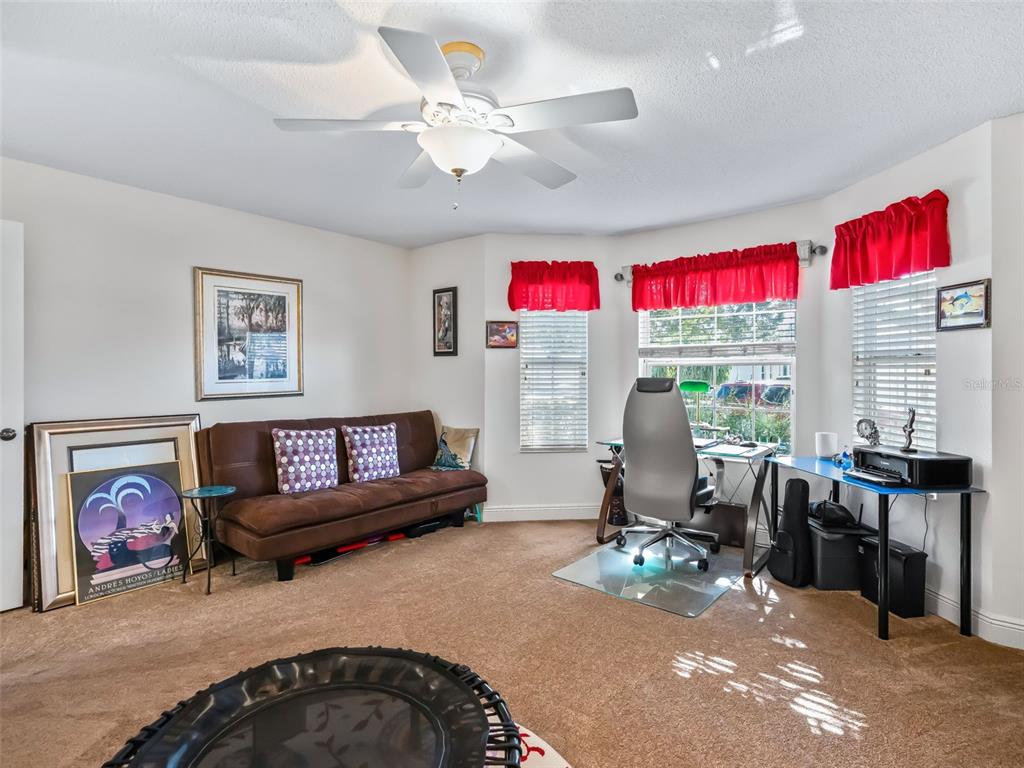 1085 Ridgeland Path The Villages, FL 32162 - Photo 34 of 56 a living room with furniture a rug and a chandelier
