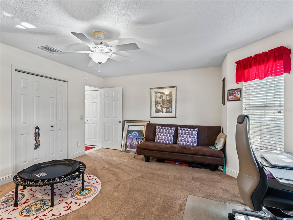 1085 Ridgeland Path The Villages, FL 32162 - Photo 35 of 56 a living room with furniture and a window
