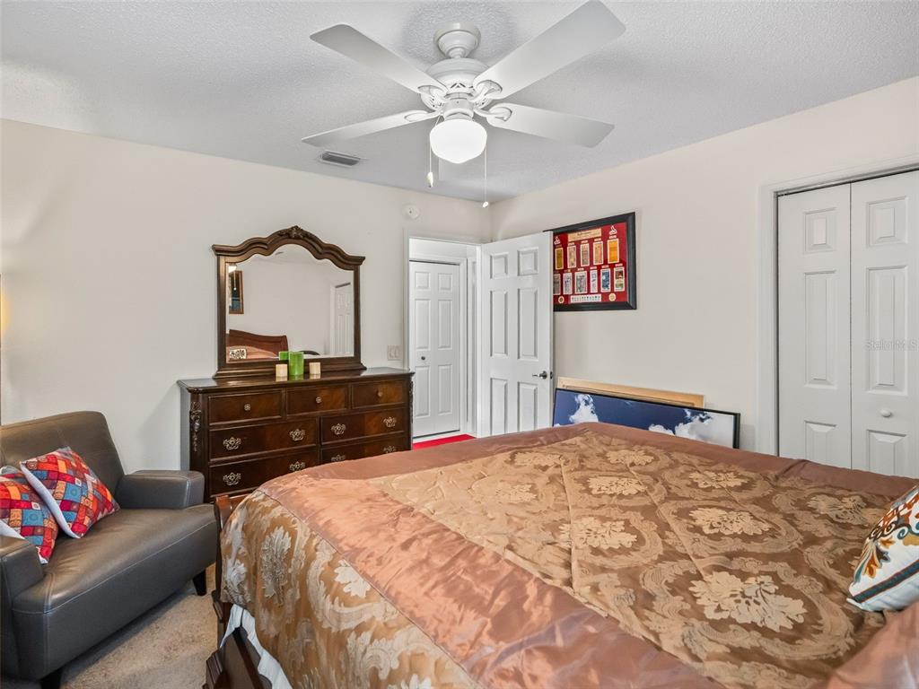 1085 Ridgeland Path The Villages, FL 32162 - Photo 37 of 56 a bedroom with a bed and a dresser