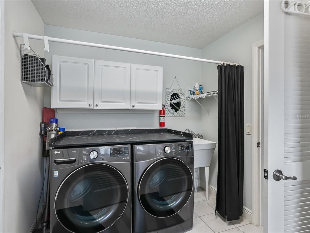 1085 Ridgeland Path The Villages, FL 32162 - Photo 39 of 56 a utility room with dryer and washer