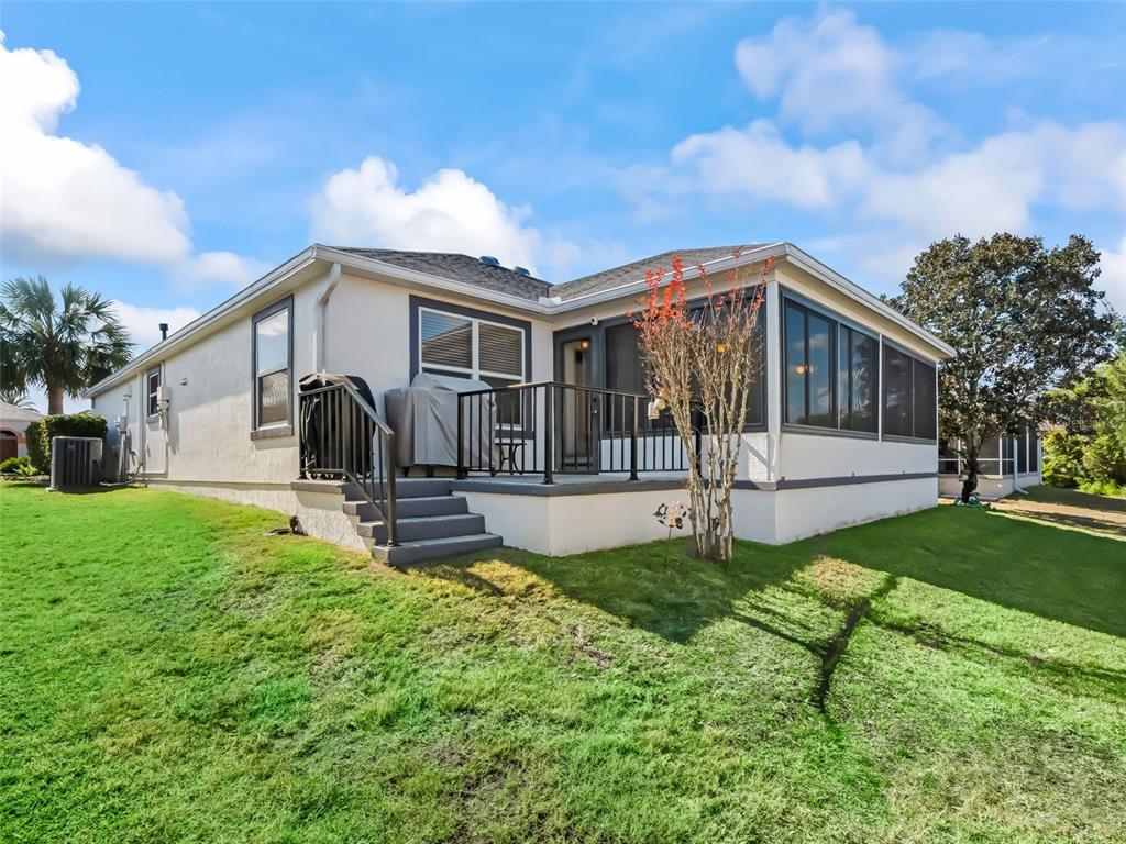 1085 Ridgeland Path The Villages, FL 32162 - Photo 42 of 56 a view of a house with backyard and a tree