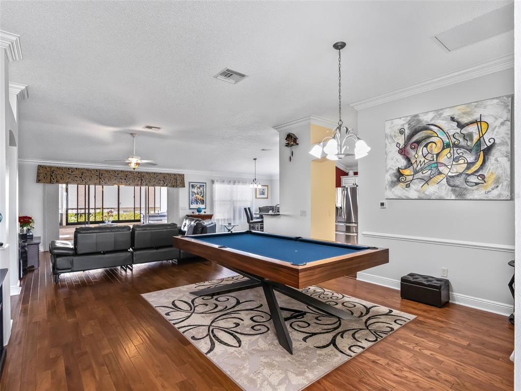 1085 Ridgeland Path The Villages, FL 32162 - Photo 7 of 56 a living room with furniture and a wooden floor