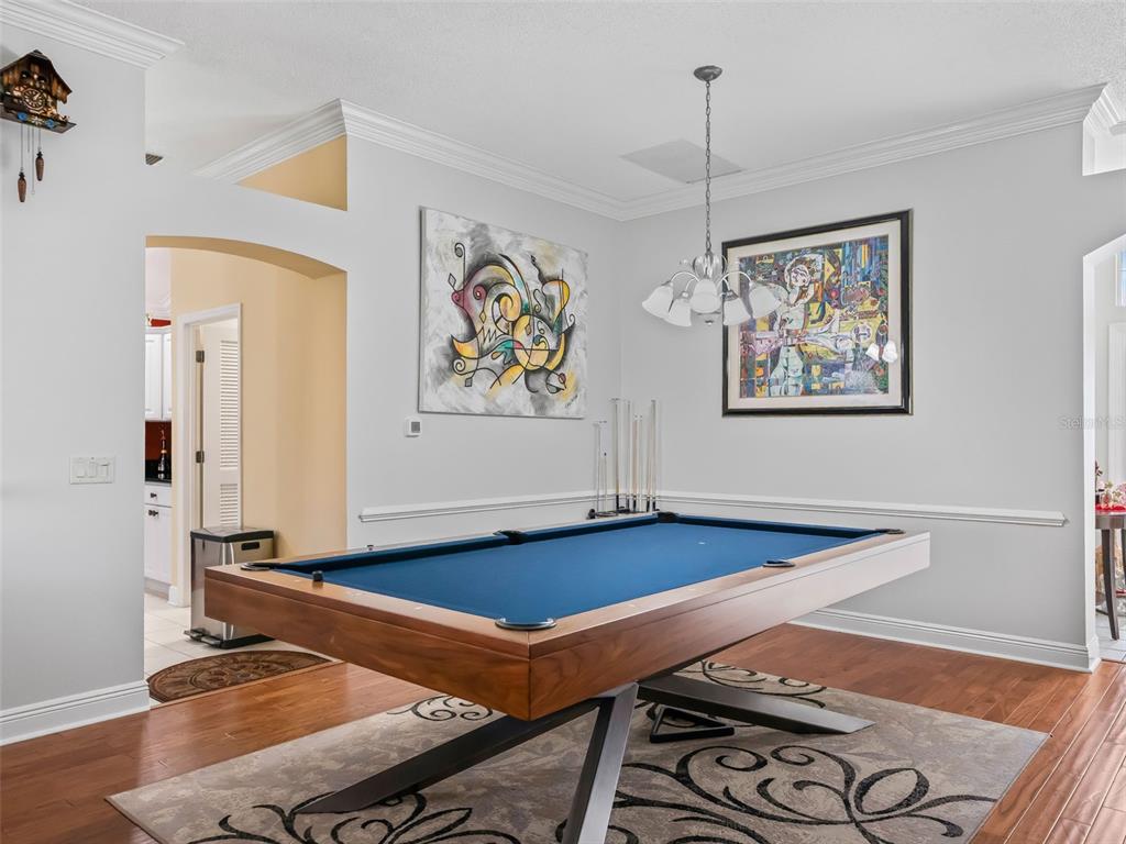 1085 Ridgeland Path The Villages, FL 32162 - Photo 8 of 56 a blue room with pool table and windows