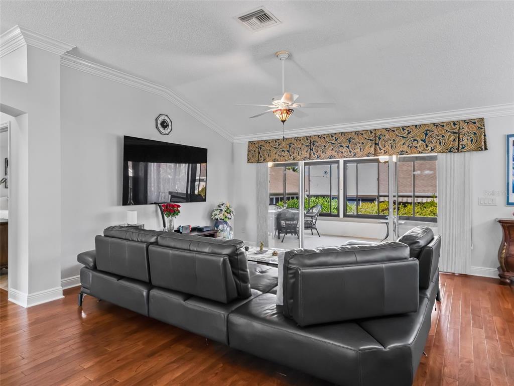 1085 Ridgeland Path The Villages, FL 32162 - Photo 10 of 56 a living room with furniture and a wooden floor