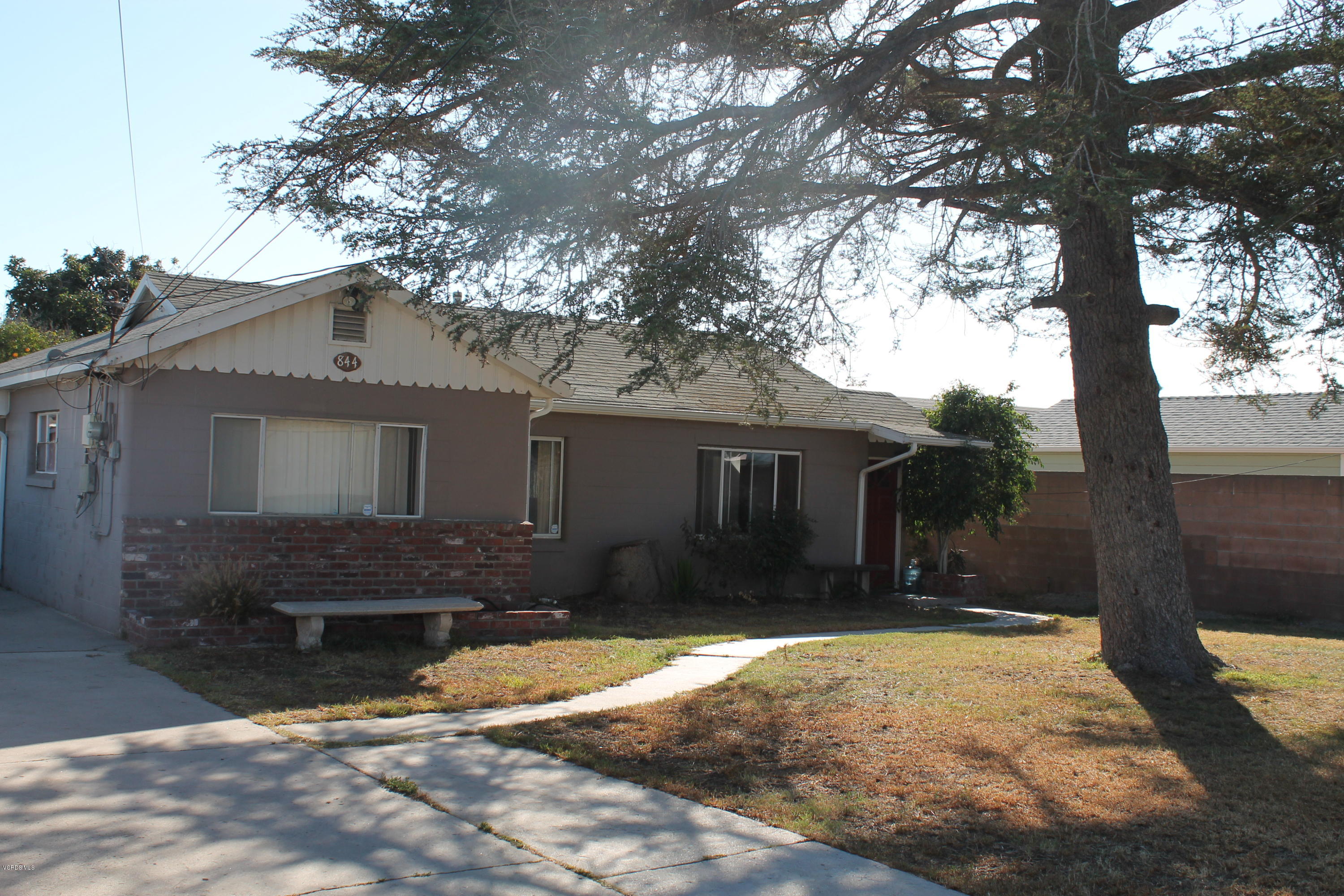 838 East Stroube Street Oxnard, CA 93036 - Photo 2 of 13 a front view of a house with a yard and garage
