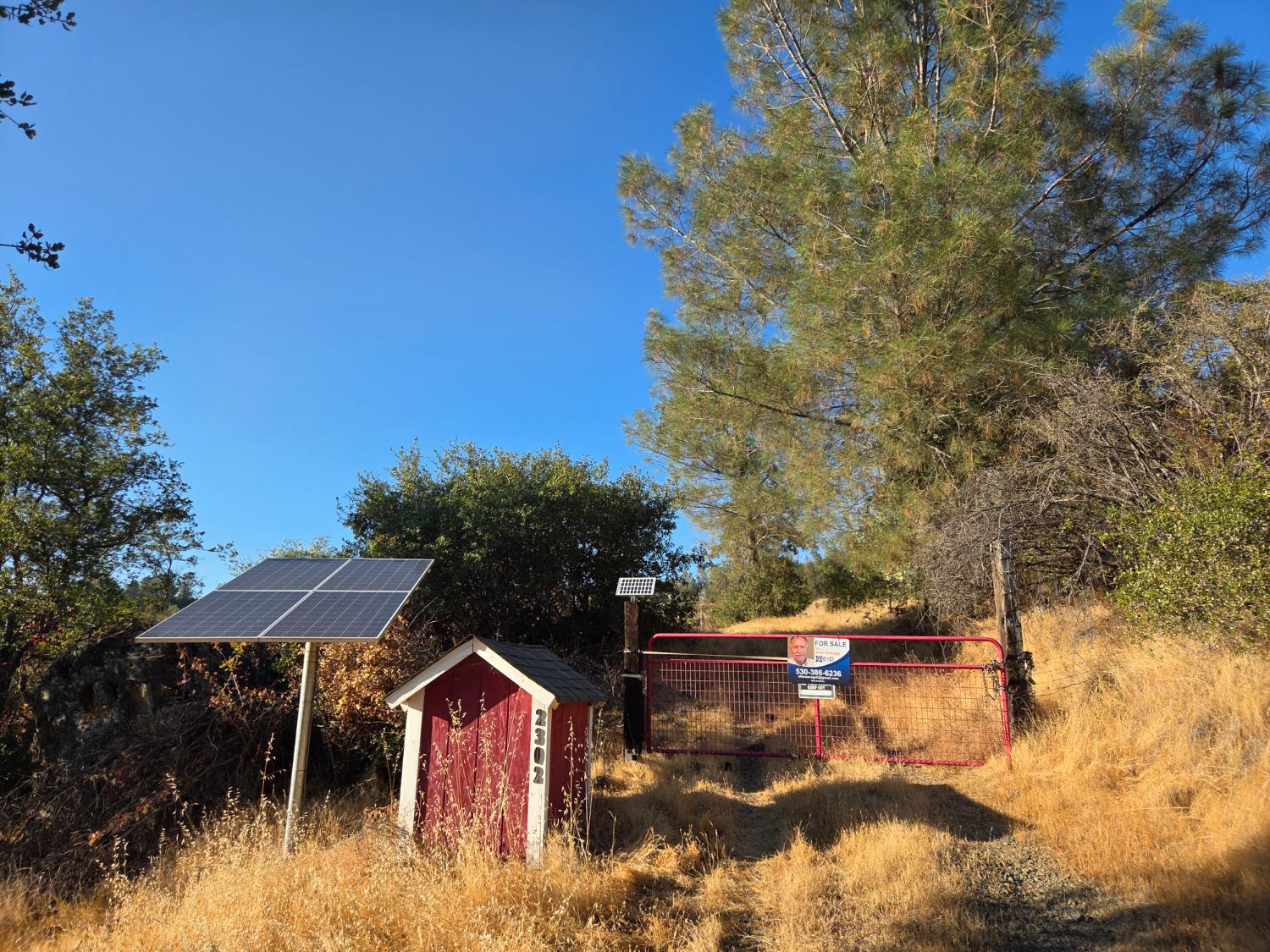 a view of swimming pool with lawn chairs under an umbrella