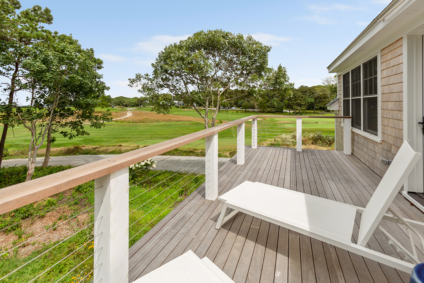 70 Curtis Lane Edgartown, MA 02539 - Photo 27 of 34 a view of a deck with couches wooden floor and fence next to a yard