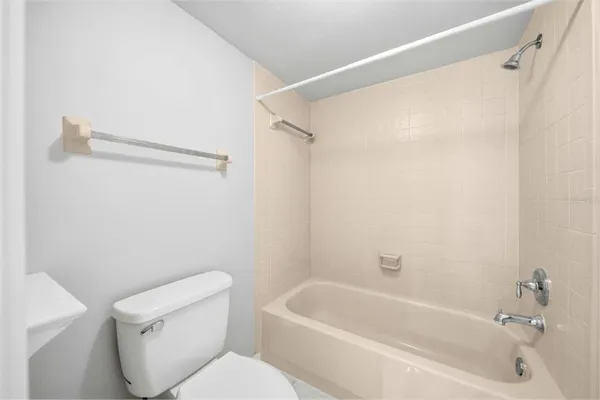a white bath tub sitting next to a white toilet and sink