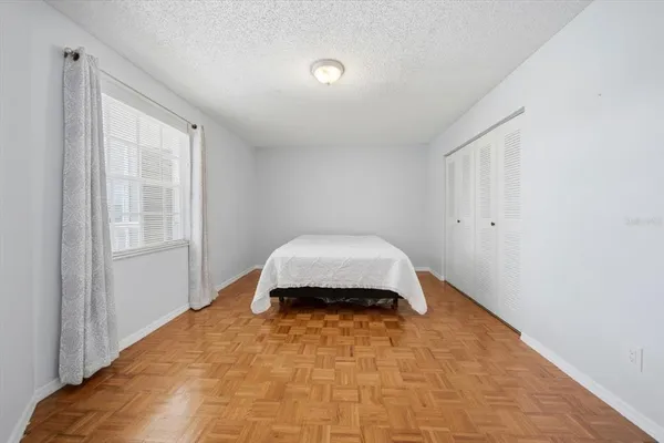 a bedroom with a bed and a window