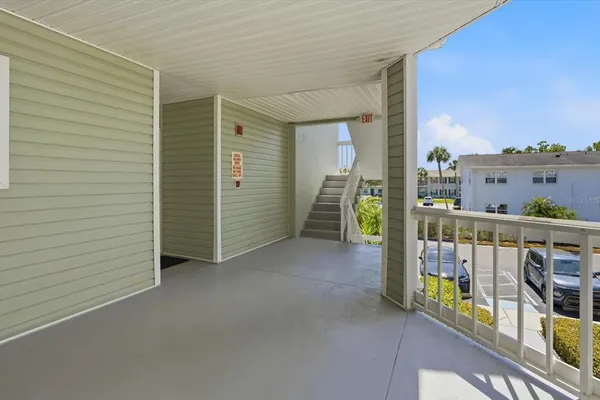 a view of a balcony with furniture