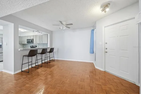 a view of a livingroom with furniture and a ceiling fan