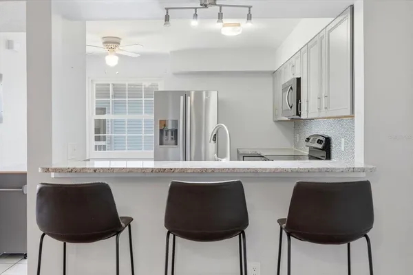 a kitchen with stainless steel appliances granite countertop a stove a sink and cabinets