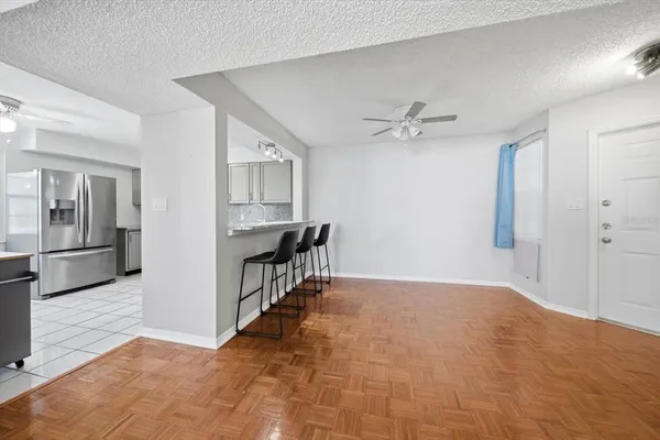 a view of an empty room with a kitchen