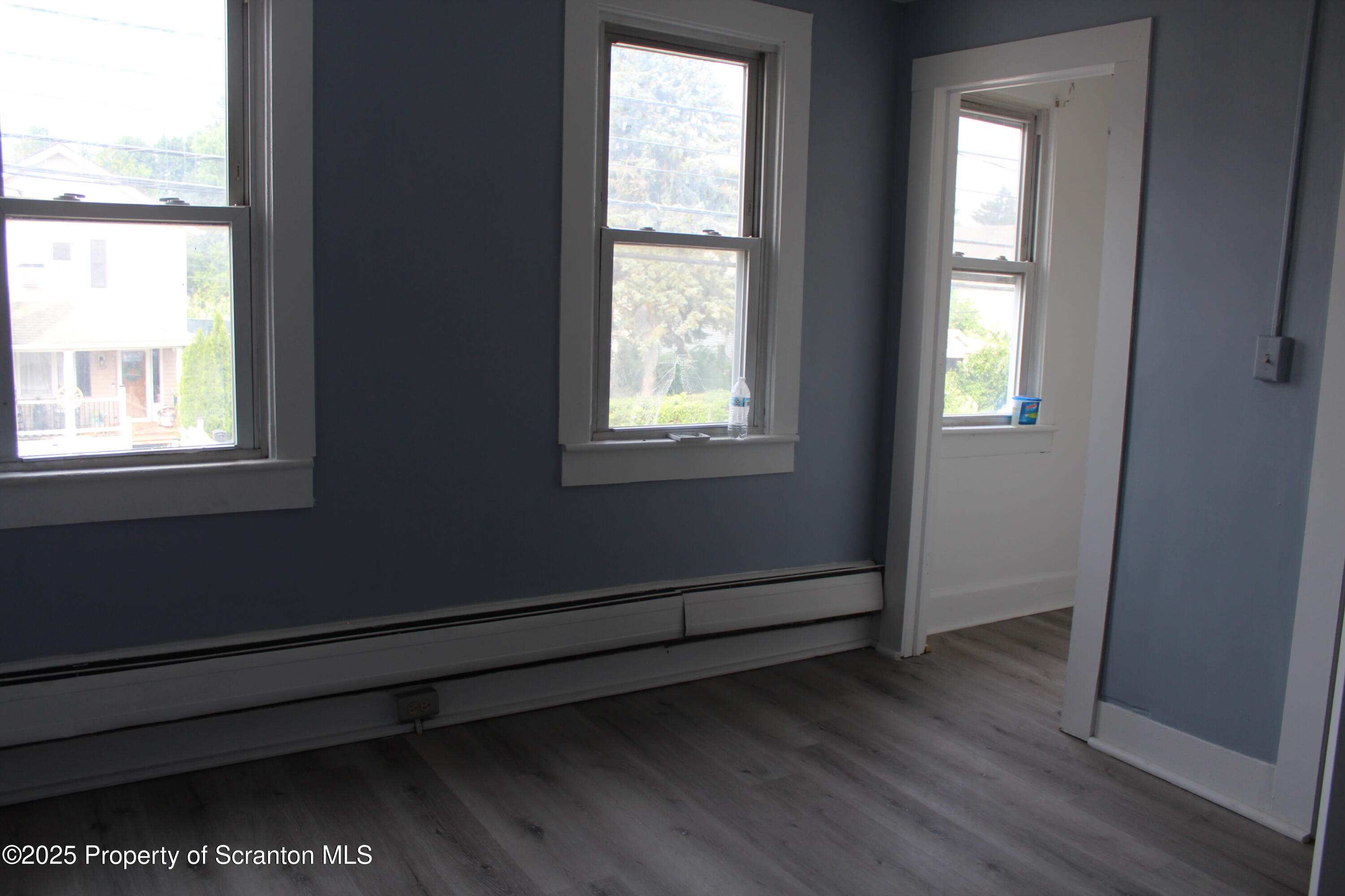 1507 Luzerne Street Scranton, PA 18504 - Photo 21 of 26 an empty room with wooden floor and windows