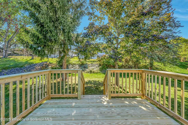 a view of a balcony with wooden floor