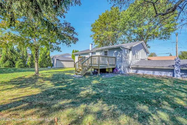 a view of a house with a backyard