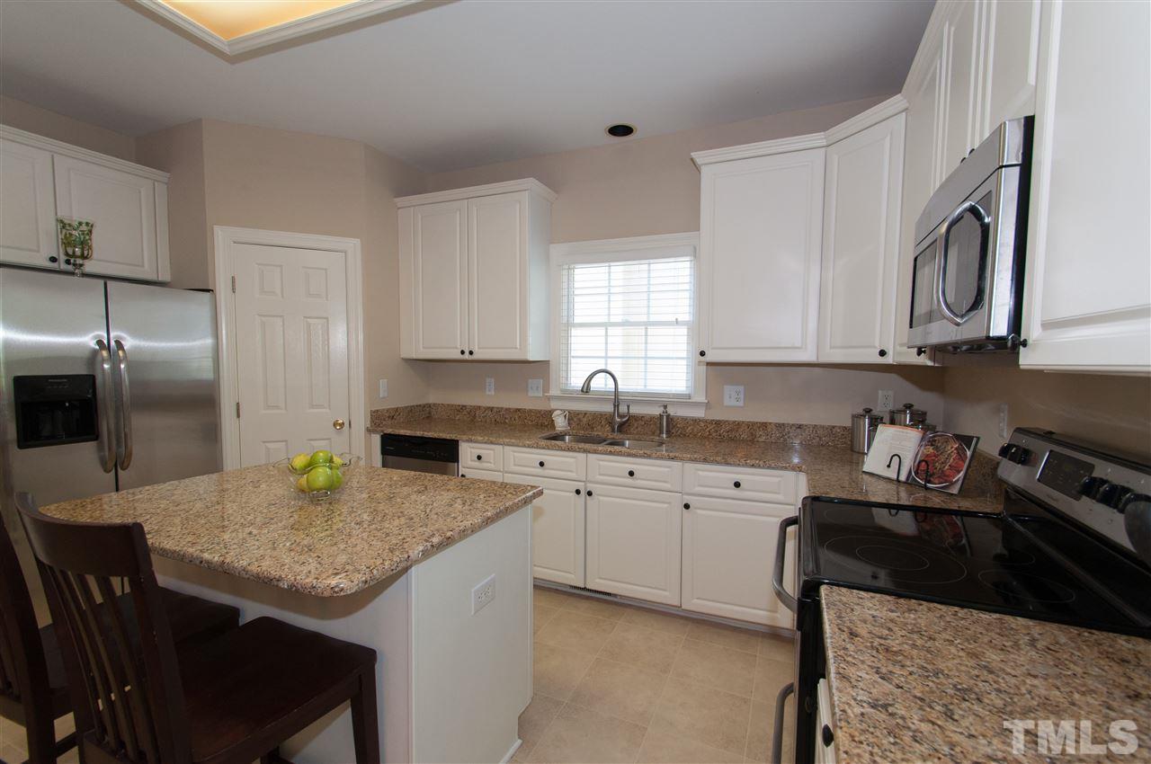 8905 Braceridge Road Raleigh, NC 27613 - Photo 2 of 25 a kitchen with a sink dishwasher a stove and a refrigerator