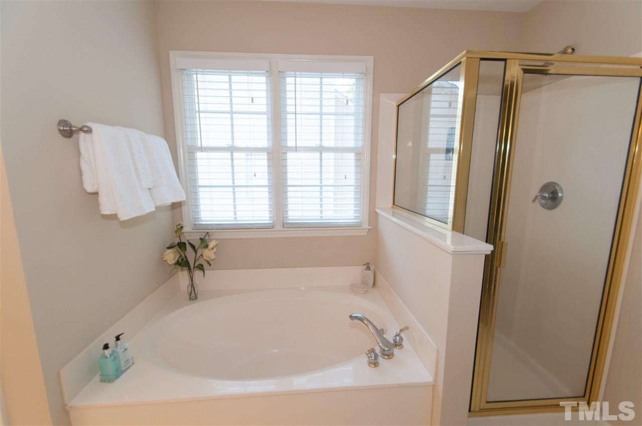8905 Braceridge Road Raleigh, NC 27613 - Photo 16 of 25 a white bath tub sitting next to a shower