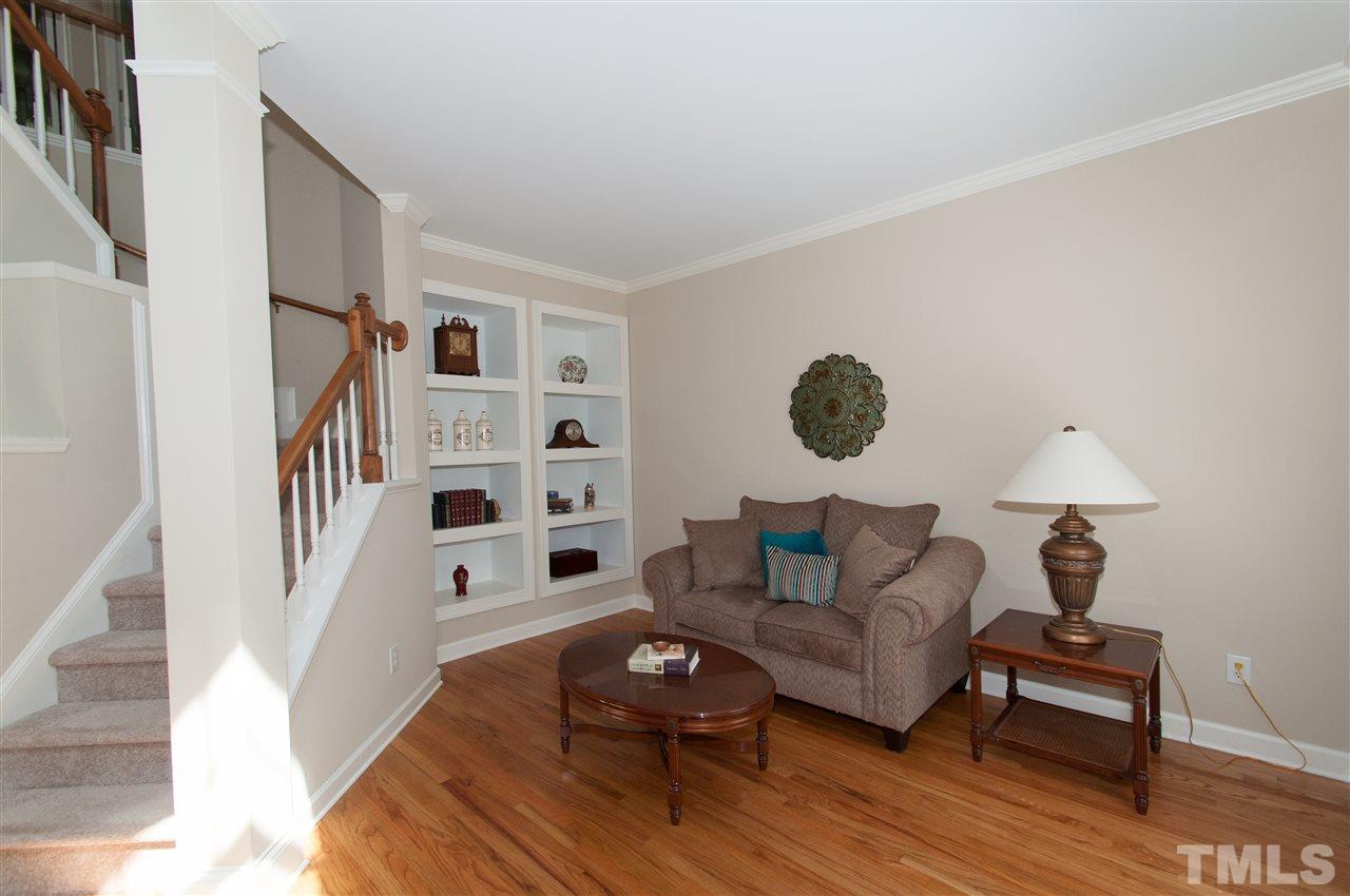 8905 Braceridge Road Raleigh, NC 27613 - Photo 18 of 25 a living room with furniture and a wooden floor